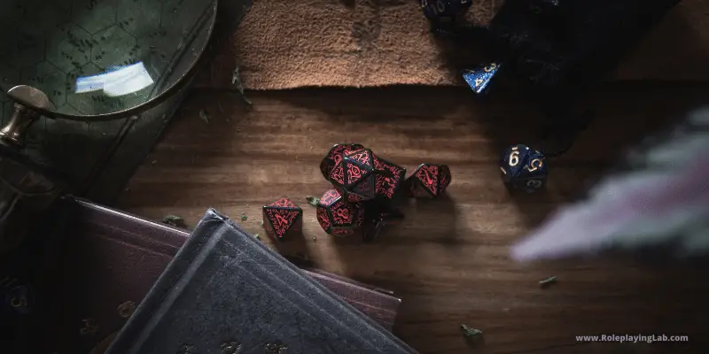 Roleplaying dice on a table with other items3Can You Kill gods in D&D